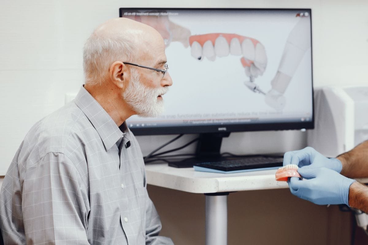Patient discussing dental implant treatment with a dentist